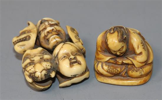 A Japanese ivory netsuke carved with nine Noh masks and another of a seated man asleep, both signed (2)